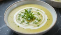 Bowl of velouté de cresson garnished with herbs